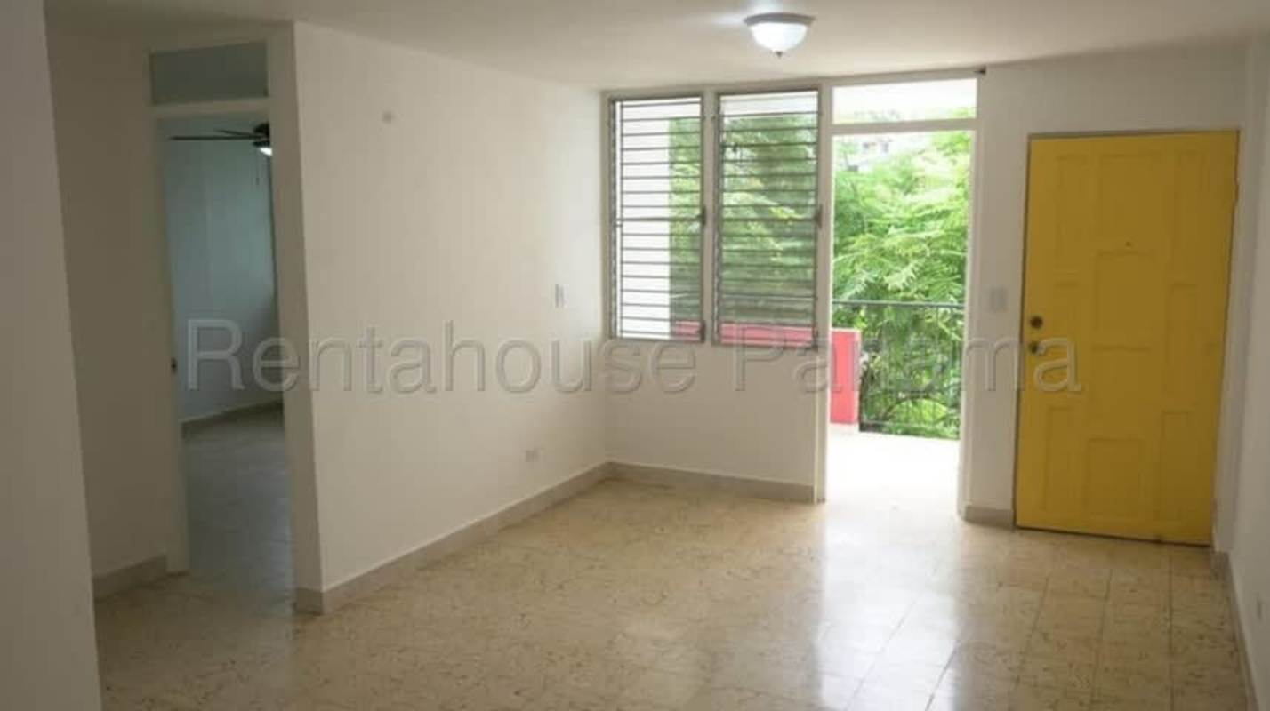 Living room area with large windows and balcony access in Parcque Lefevre Panama apartment