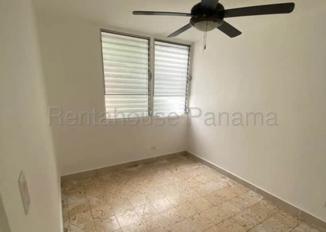 Unfurnished bedroom with tile floor, louvered windows, ceiling fan in Parque Lefevre Panama apartment