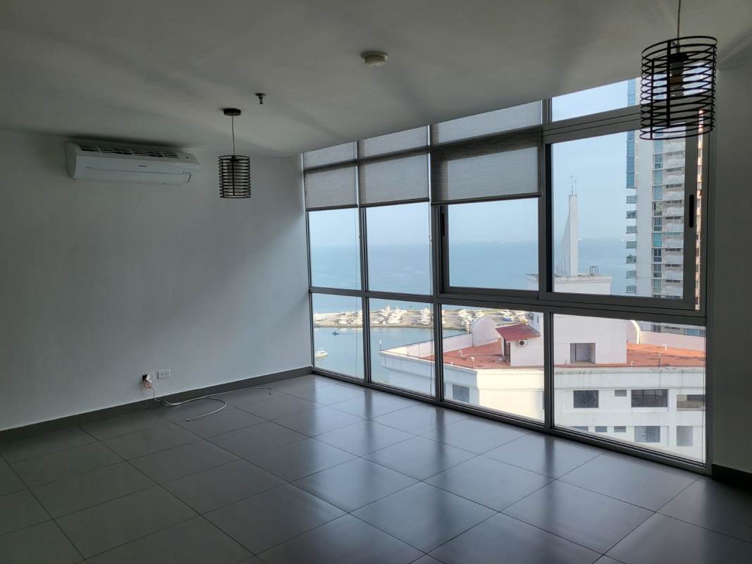Bedroom featuring built-in closet, split AC and ocean view at PH Colores de Bellavista Panama City