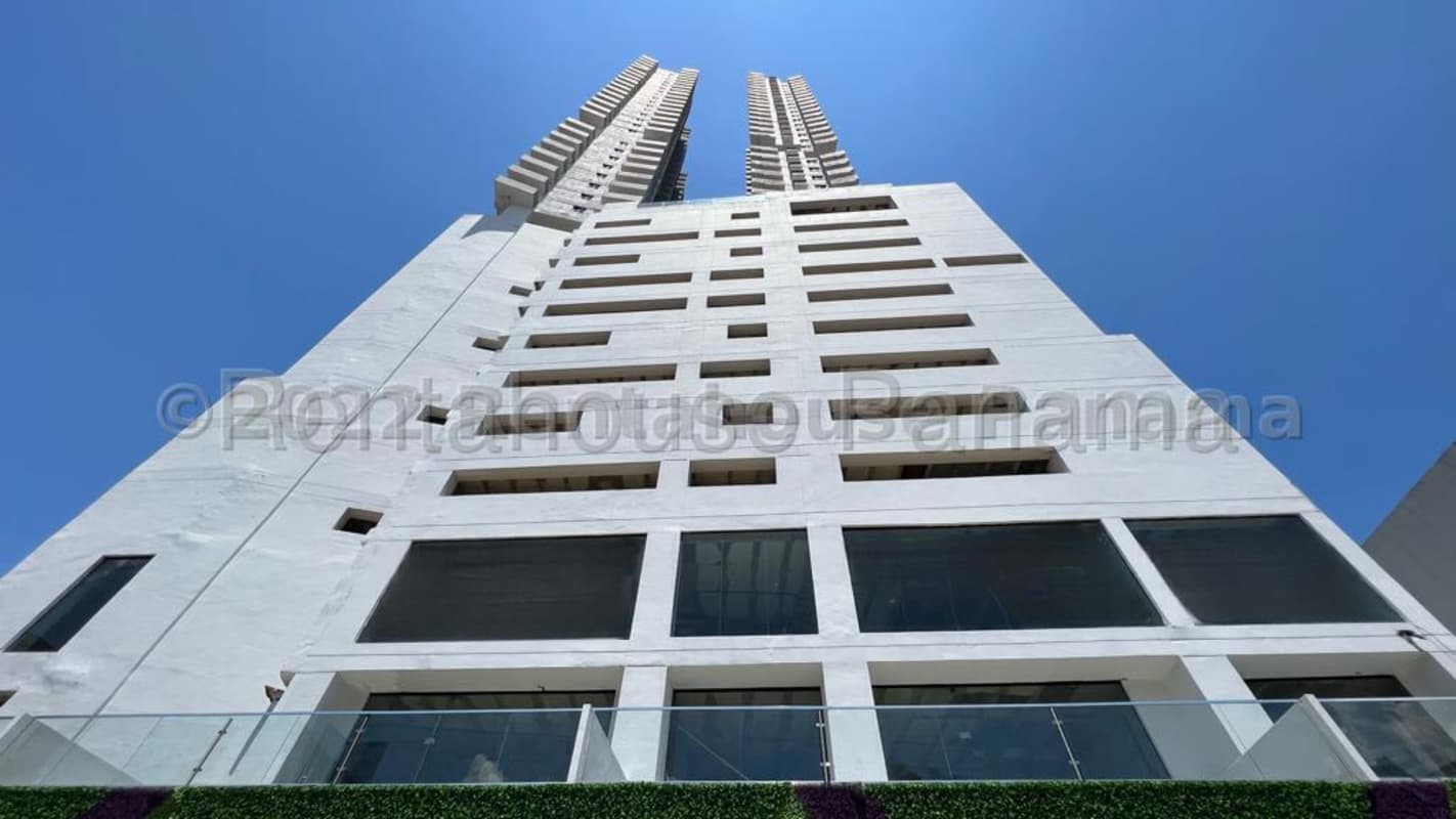 Exterior vertical view of twin tower Plaza España commercial complex Panama City with blue sky background