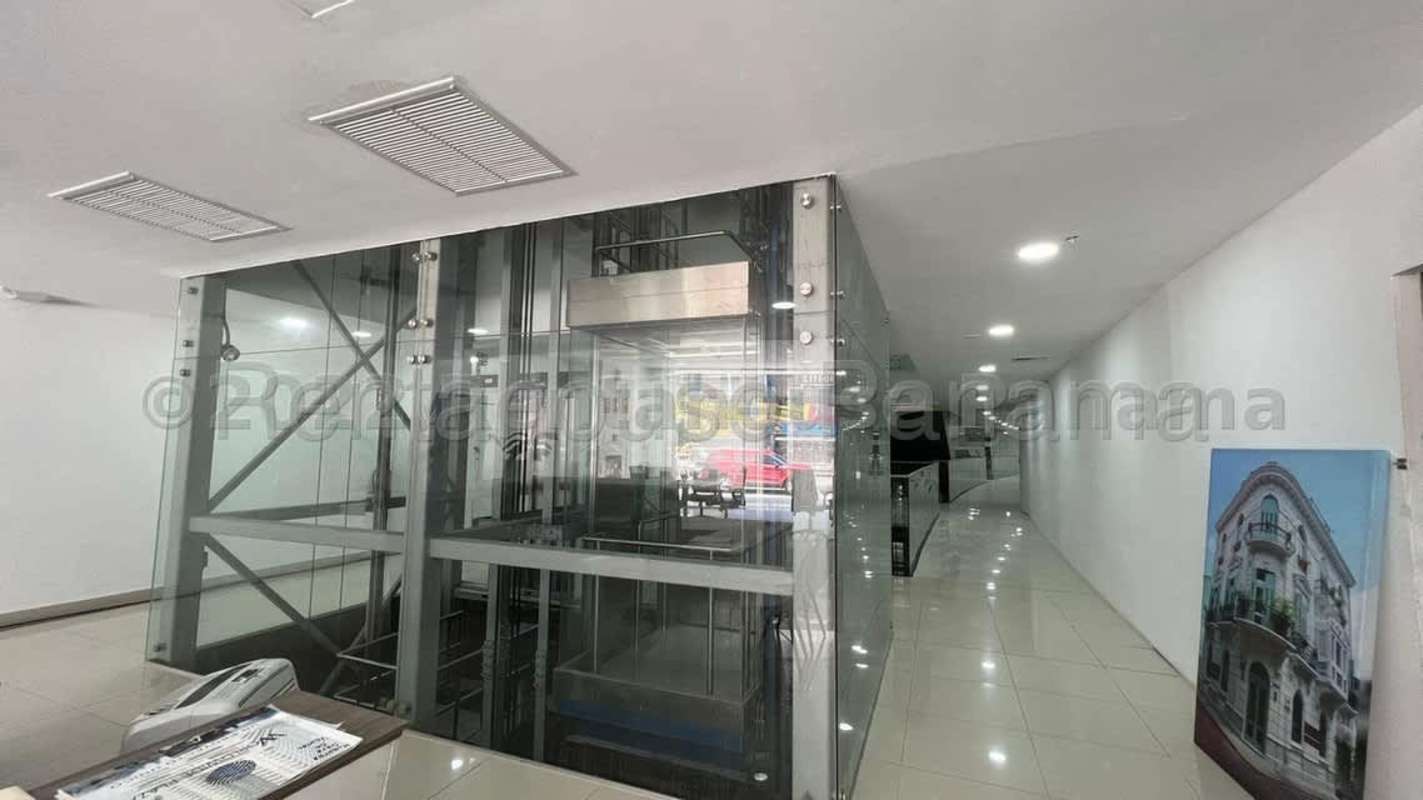 Lobby interior with glass elevator and bright ceiling PH Plaza España business plaza Panama