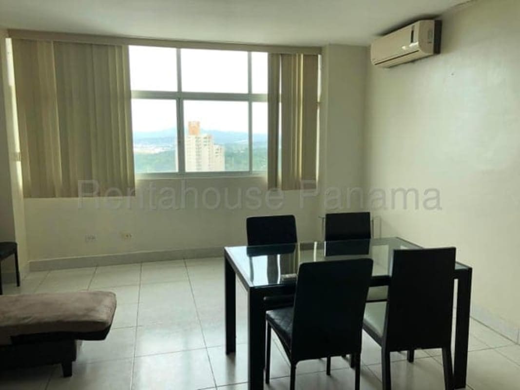 Dining area with glass table and city view window at PH Vivendi Edison Park