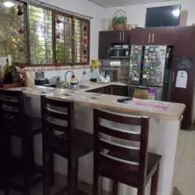 Kitchen with L-shaped counters, large window, bar stools Tocumen Panama