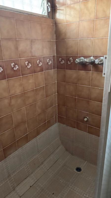 Bathroom with vintage tiles and built-in shower area for rent house Juan Pablo II Panama City