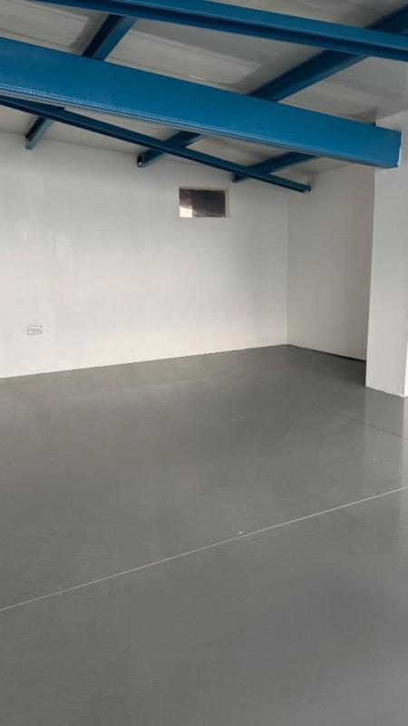 Open space with painted beams and concrete floor ideal for storage or workspace Panama City