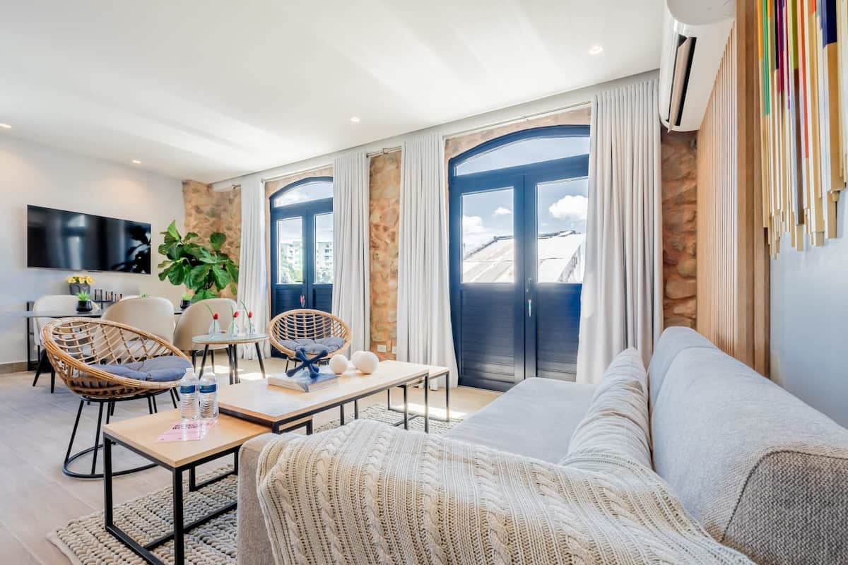 Designer kitchen with island, geometric backsplash, and stainless steel appliances in PH La Cuadra San Felipe