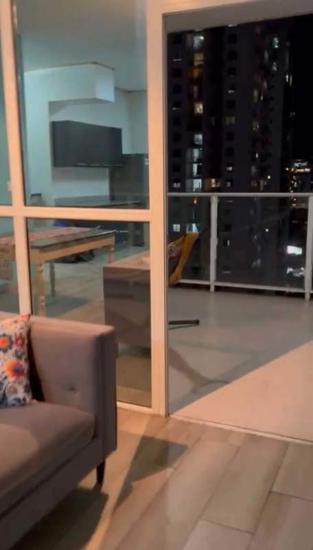 Modern open concept living area with kitchen and balcony in PH Quadrant San Francisco, night city views