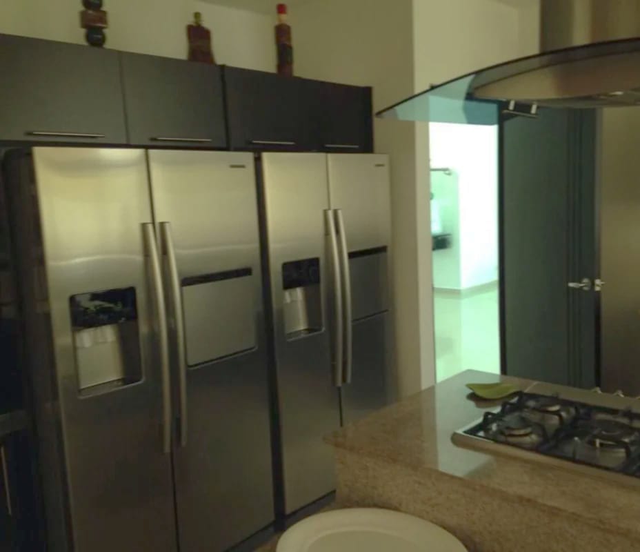 Modern kitchen with island, granite countertops, stainless appliances in luxury house Panama