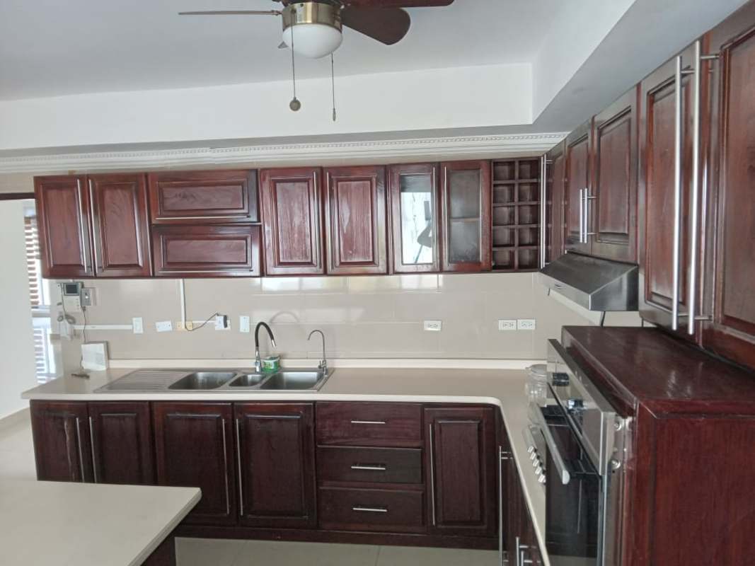Large traditional kitchen island granite counters wood cabinetry San Francisco Panama house