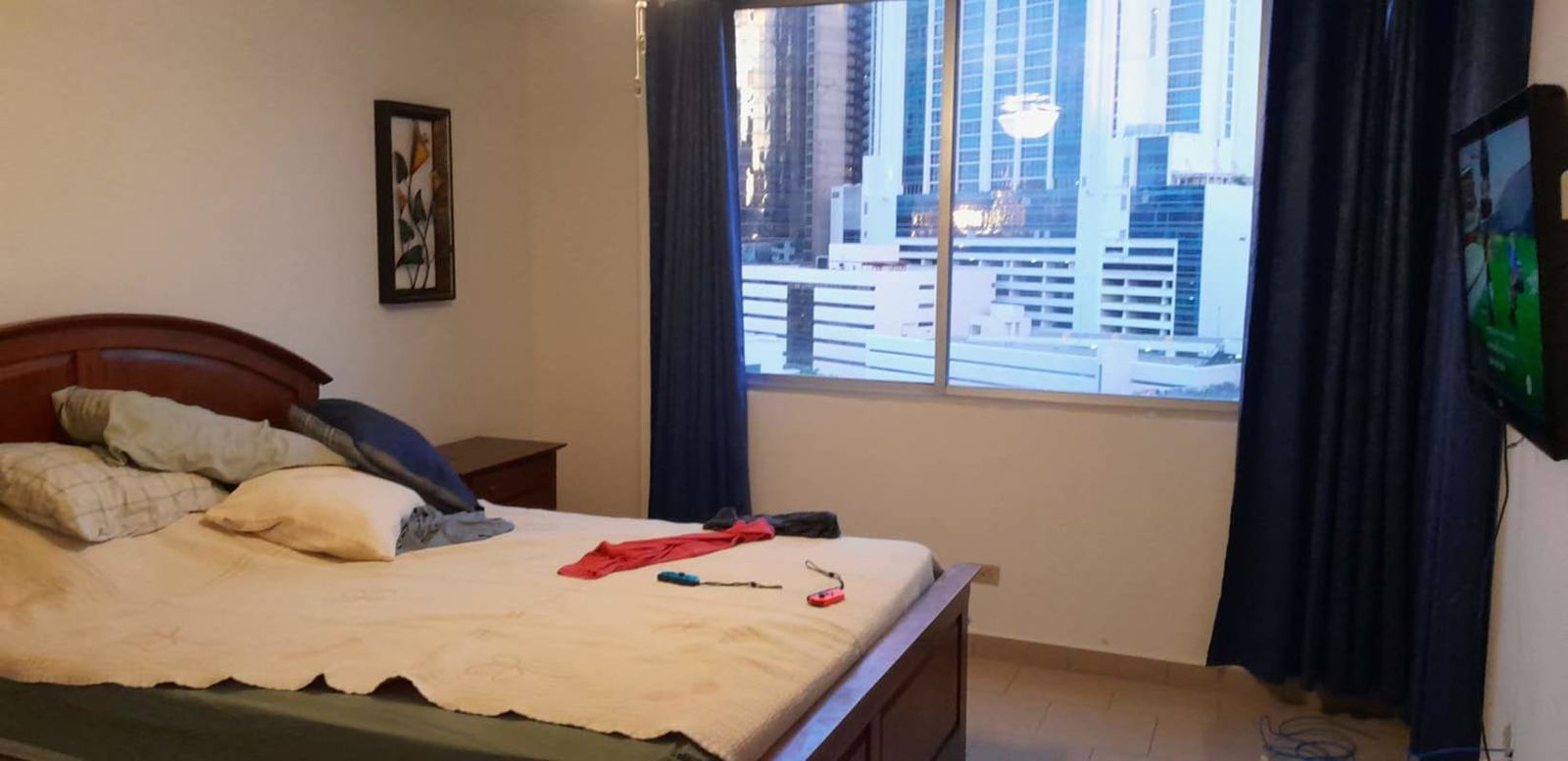 Bedroom with large window overlooking Panama City skyline PH Marina Plaza Marbella