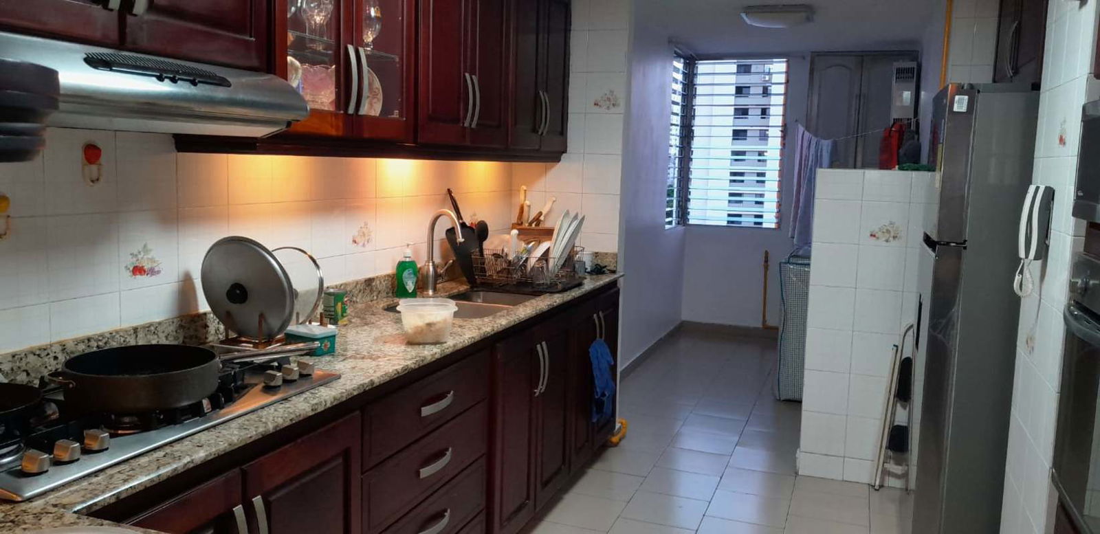 Traditional kitchen granite countertops wood cabinets large window PH Marina Plaza Panama City