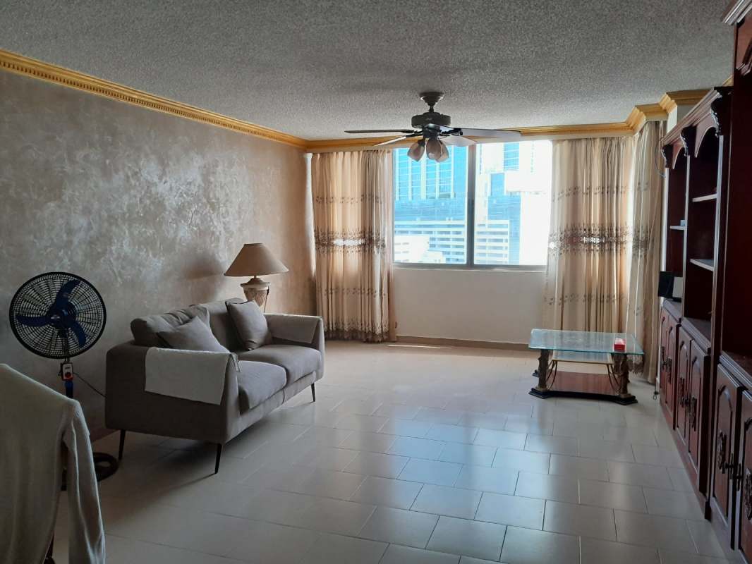 Living room with large cityscape view window, gray sofa PH Marina Plaza Marbella Panama