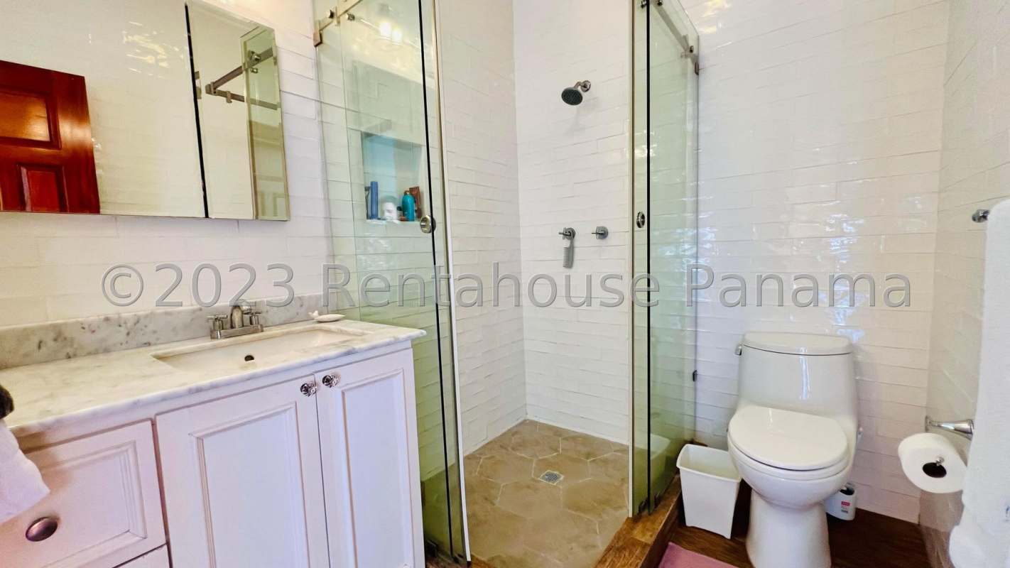 Remodeled bathroom featuring glass-enclosed shower, marble countertop, contemporary design Panama City