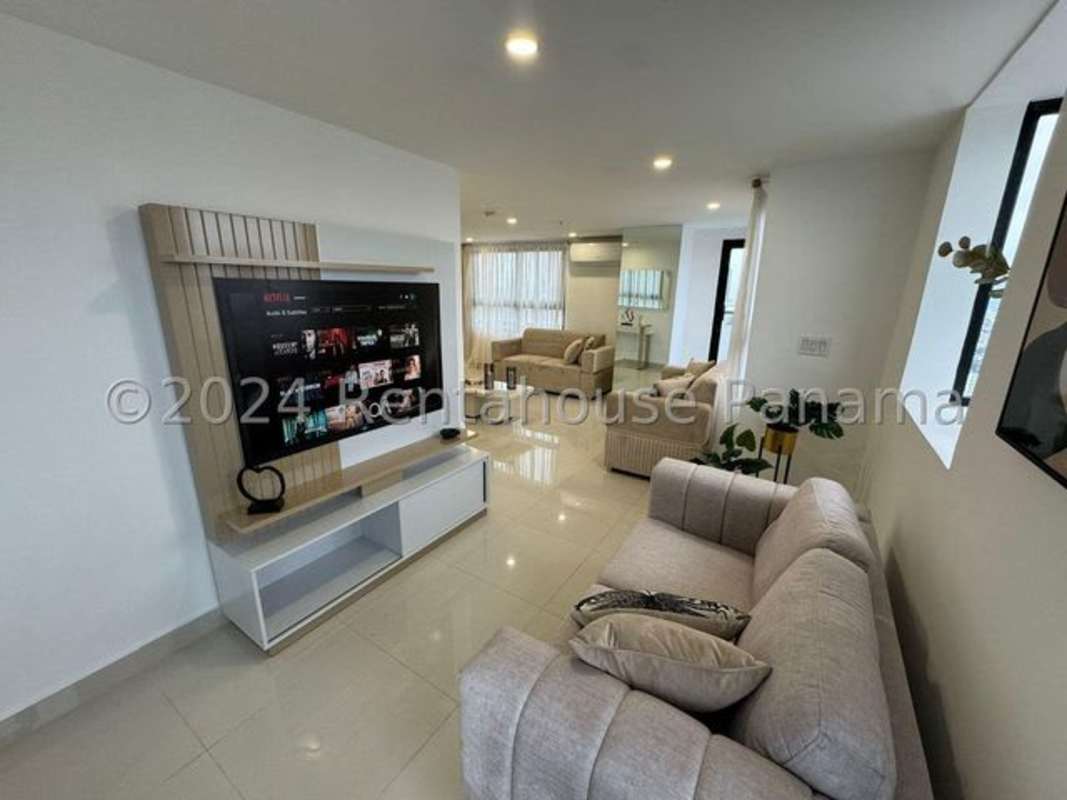 Modern condo living room with large windows and balcony access in Panama City