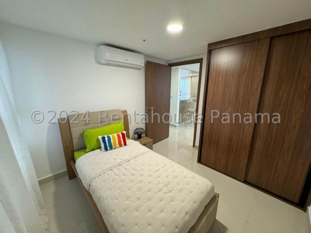 Open kitchen with granite countertops, stainless appliances, breakfast bar and large windows in Panama City condo