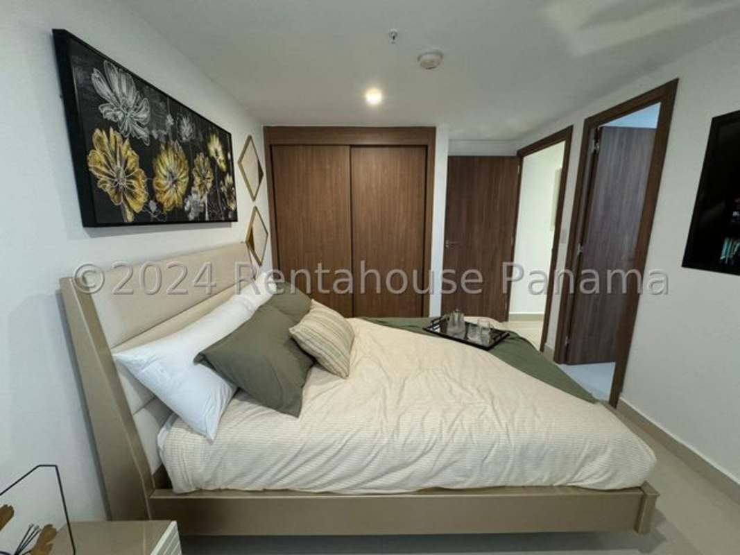 Modern living room with large windows, polished tile, elegant furniture and city skyline view in Panama City apartment