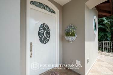 Spacious living area with garden views, large TV, wood floors in Valle Escondido Boquete luxury house