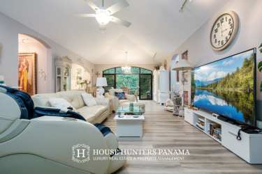 Living room with vaulted ceiling arched window garden views luxury house Boquete Panama