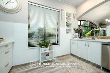 Kitchen with white cabinets large window and decorative accents luxury home Boquete Panama