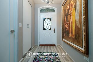 Entryway with artwork colorful rug chandelier Valle Escondido Boquete Panama