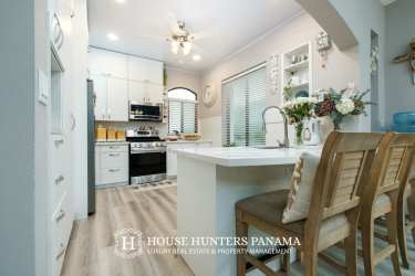 Formal dining space with large window overlooking gardens in Valle Escondido Boquete