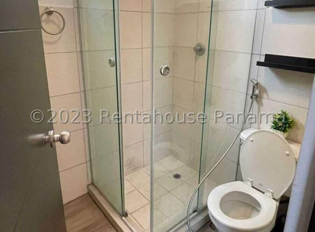 Modern bathroom with glass shower, toilet, tiled walls in PH Parque Lefevre Panama