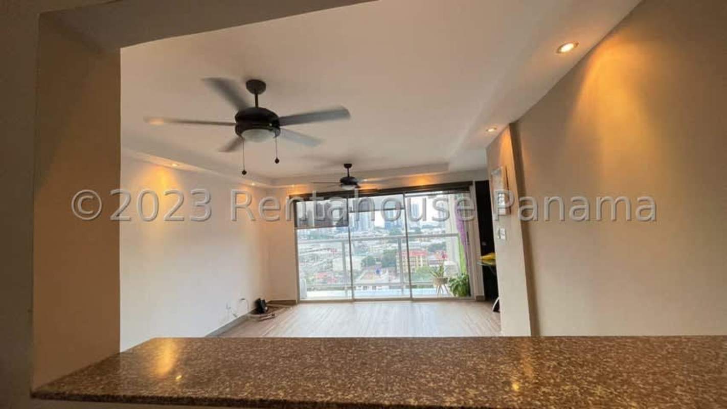Modern living space with balcony access, ceiling fans, city view in PH Parque Lefevre Panama