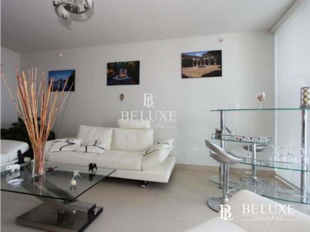 Dining area with glass table and city views in PH Country Club Costa del Este Panama