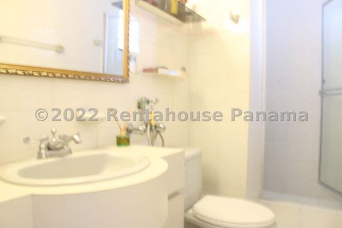 Bright white bathroom with large mirror and glass shower PH Marbella 25 Panama City