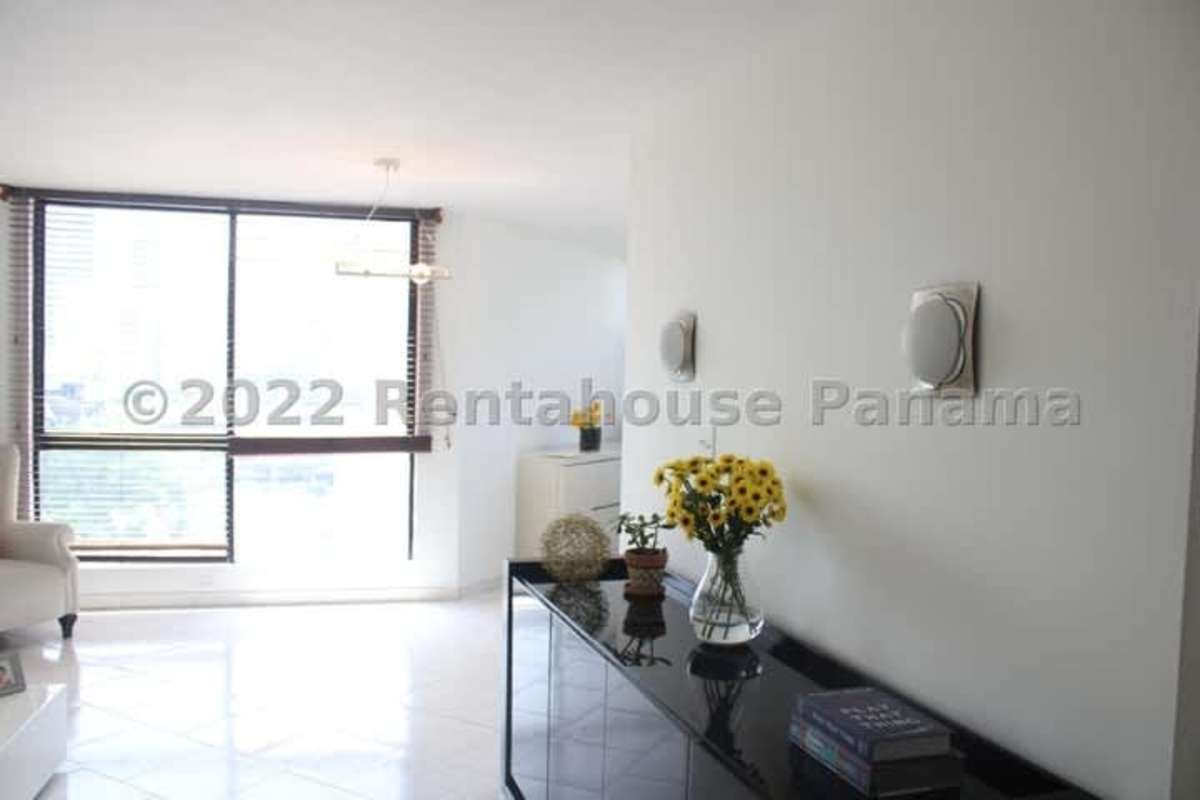 Contemporary living room with big glass window, tiled floors and stylish decor at PH Marbella 25 Panama City