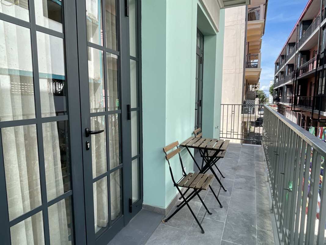 Living room with green sofa, accent chair, modern furnishings in Santa Ana Casco Viejo Panama