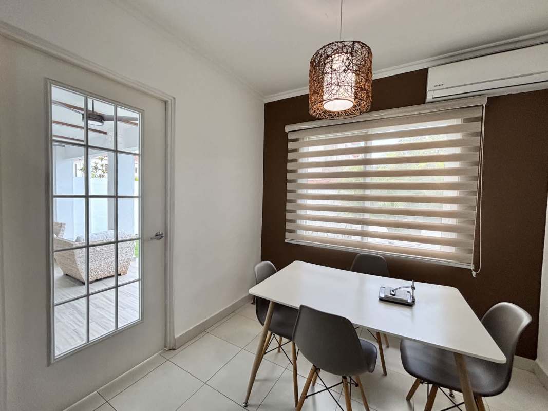 Modern kitchen with granite countertops and dining area in Costa Sur house