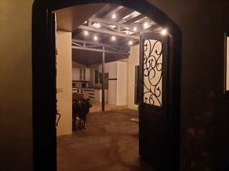 Large covered terrace patio with cooking area and greenery views at countryside house Campana Panama