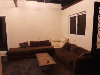 Large living room with sectional sofa and natural wood beams countryside Campana