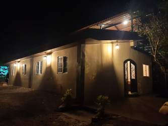 Country house exterior with spiral staircase to panoramic deck in Panama countryside