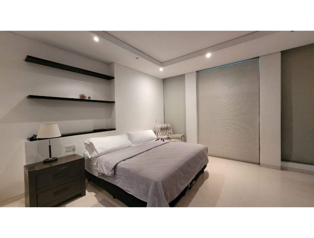 Large master bedroom with walk-in closet, marble floor, and ocean view balcony in PH Pacific Point Punta Pacifica