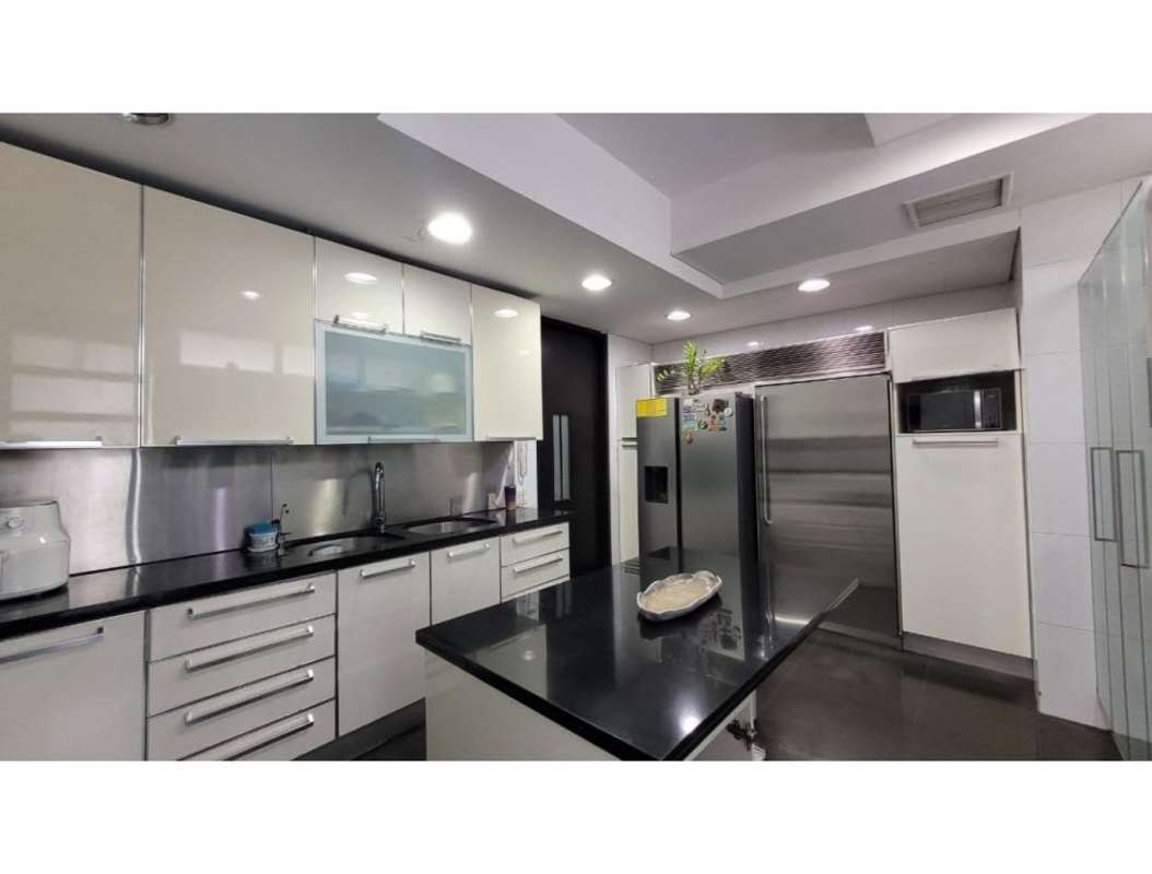 Modern kitchen with granite countertops, island, stainless steel appliances in PH Pacific Point Punta Pacifica Panama