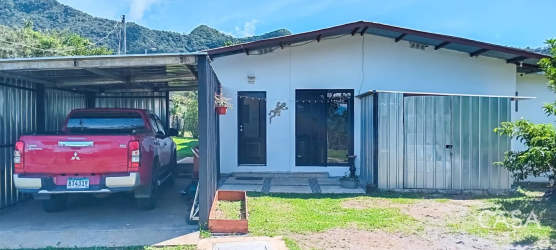 Countryside home with garden, patio cover, mountains in background in Gualaca Chiriquí Panama