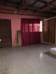 Simple bedroom with pink walls and tile floors in large Montijo house for sale Panama