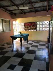 Rustic enclosed porch with checkered tile floors and metal roof Montijo Veraguas Panama