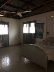 Simple bedroom with tiled floor and window Montijo Veraguas Panama