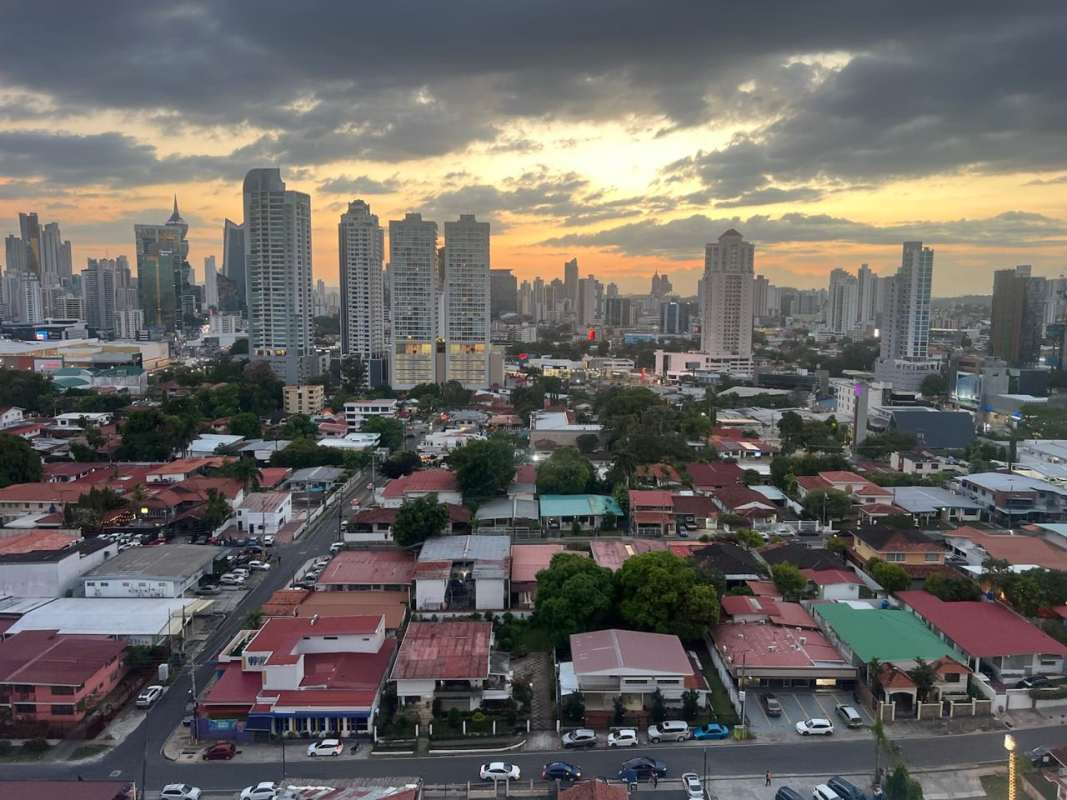 Open dining area connected to living room with city skyline views for rent Panama