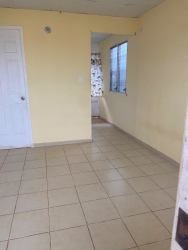 Empty interior room with yellow walls tiled floor window Panama affordable rental
