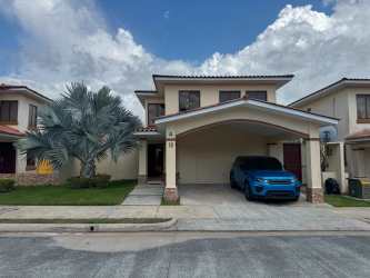 Two-story house with tile roof, driveway, in Senderos de Bambú residential Panama