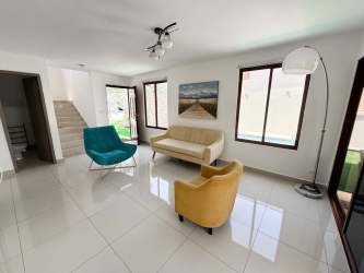 Spacious bright living room with modern lighting, tiled flooring, and garden view