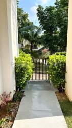 Spacious covered terrace patio overlooking garden, ideal for entertaining in Panama Pacifico home