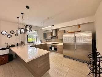 Large living and dining space with terrace access and garden view in Panama Pacifico property for sale