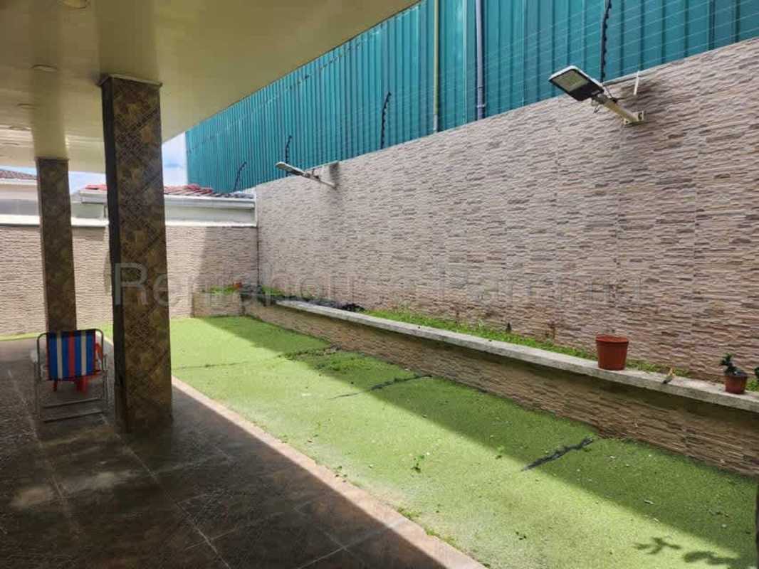 Garden terrace with greenery and stone wall in Panama luxury home