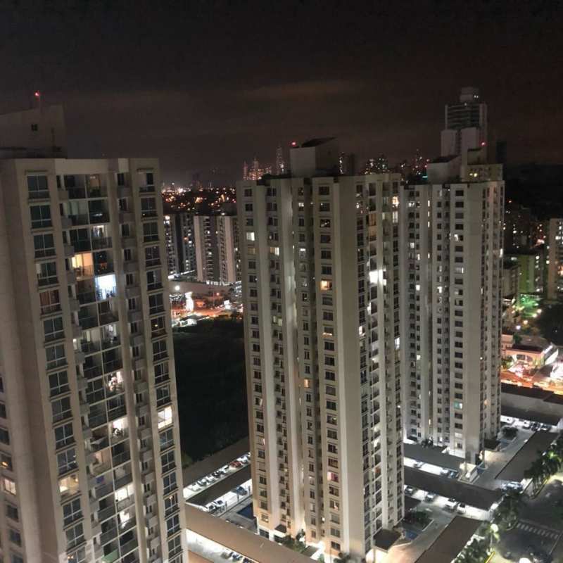 Night skyline of PH Rokas towers Condado del Rey with illuminated apartments in Panama City