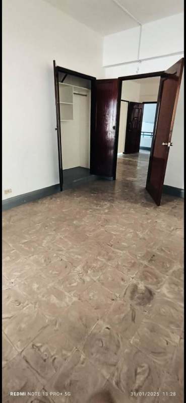 Bathroom with blue tiled walls, pedestal sink, toilet, and small window PH Via Veneto Panama